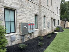 an outside view of a building with grass and bushes