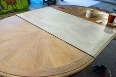 a table that has been made with wood and is being worked on by someone else