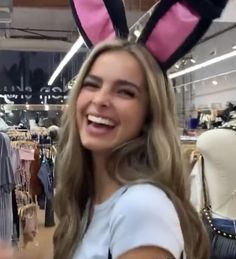 a woman wearing bunny ears in a clothing store