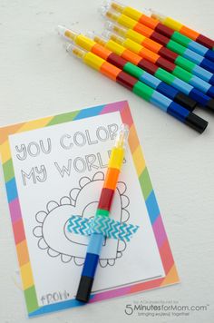 colored crayons are next to a coloring book that says you color my world