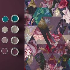 several tins with flowers on them next to a purple wallpaper and two different shades of paint