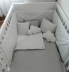 a crib with pillows and stuffed animals in it