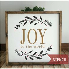 a sign that says joy to the world with an image of leaves and berries on it