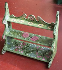 a green bench sitting on top of a red floor