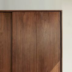 a wooden cabinet with two doors on the front and one door open to reveal an empty room