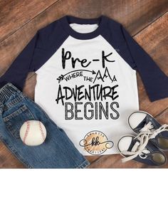 a baseball shirt with the words pre k where the adventure begins on it next to some shoes