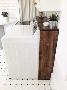 a washer and dryer sitting next to each other in a room with white walls