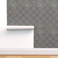 a wallpapered room with a gray and gold pattern