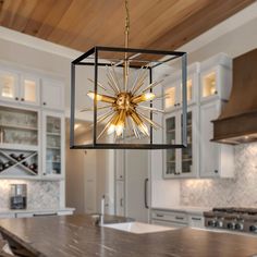 a chandelier hanging from the ceiling in a kitchen