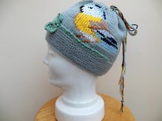 A hand knit wool hat with a beautiful embroidered Blue Tit design. This unique bird beanie hat has been both hand knitted and designed by myself. Handmade with pure merino wool its both soft and warm.  Just a little tweet! its one of a kind and makes a very special gift for any special occasion so hurry its sure to fly out of the shop! One size fits all. Head circumference 21 - 24 inches. Handmade knitted hat with merino wool in grey with cotton embroidered bird design. Care instructions Machine Knitted Wool Beanie, Wool Hat Knit, Embroidered Bird, Unique Hats, Hand Knit Hat, Hat Collection, Wool Beanie, Knitted Hat, Bird Design