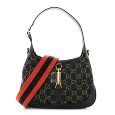 This is an authentic GUCCI Jacquard Denim GG Monogram Small Jackie 1961 Hobo in Black and Ivory. This Gucci hobo is beautifully crafted of black denim with beige Gucci monogram. The bag features black cowhide leather trim, looping adjustable leather handle with a removable strap extender, and an optional orange striped canvas shoulder strap. The crossover strap secures the top with a gold piston lock and opens to a beige fabric interior with a zipper pocket. Gucci Crossbody Bag, Gucci Crossbody, Gg Monogram, Gucci Monogram, Gucci Shoulder Bag, Beige Fabric, Bag Light, Wallet Chain, Blue Bags