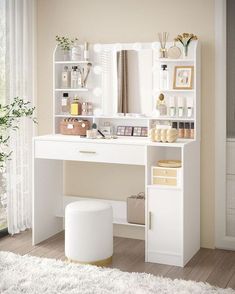 a white desk with shelves and drawers on top of it in front of a window