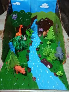 an open cardboard box with animals and trees on it