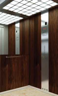 an elevator with wooden doors and glass panels on the wall, in front of a tiled floor