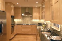 a kitchen with wooden cabinets and stainless steel appliances