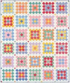 a colorful quilt with many different designs and colors on the front, along with a white background