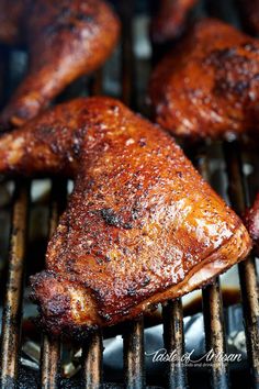 two pieces of meat cooking on top of a grill