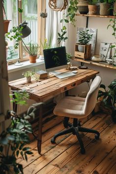 a wooden desk topped with a laptop computer sitting next to a plant filled window sill