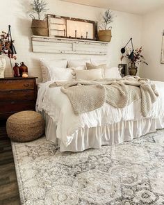 a white bed sitting in a bedroom on top of a rug