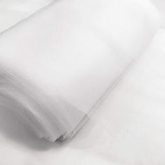 a white sheet that is laying on top of a bed