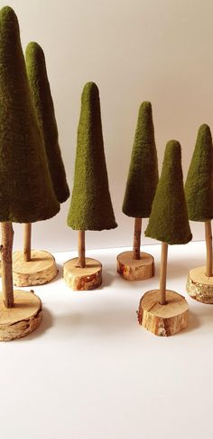 small trees made out of wood are lined up