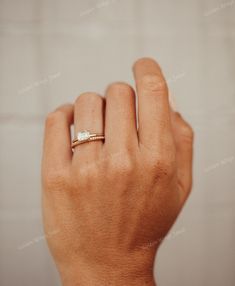 a woman's hand with a ring on it