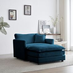 a living room with white walls and blue furniture