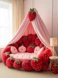 a bed made out of strawberries with a canopy over it and pillows on the floor