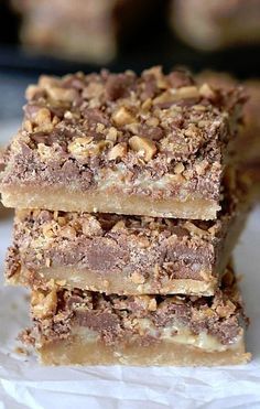 three pieces of chocolate and walnut bars stacked on top of each other, ready to be eaten