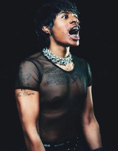 a woman with her mouth open wearing mesh clothing