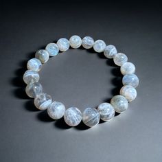 -Unlock the power of your chakras with our Labrodite Bracelet. Crafted with care, this stunning piece features natural grey Labrodite crystals that not only add a touch of elegance to your outfit but also offer incredible spiritual benefits. -Labrodite is known for its ability to remove blockages in the Third Eye and Throat Chakras, allowing for enhanced intuition and clear communication. It is believed to acts as a protective shield, safeguarding your aura from negative energy. -Choose from three bead sizes - 6mm, 8mm, and 10mm - to find the perfect fit for you. The Labradorite bracelet measures 7.5 inches and stretches to comfortably accommodate most wrist sizes. -When sunlight hits the Labrodite crystals, they come alive with mesmerizing streaks, adding a touch of magic to your day. Wit Clear Communication, Labradorite Bracelet, Chakra Bracelet, Healing Bracelets, Daughter Love, Third Eye, Unisex Design, Crystals And Gemstones, Arm Band