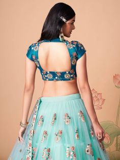 Wrapped up in the warmth of comfort and style, this pleasant sky blue color lehenga is formed with net material designed with mirror work, thread embroidery, and sequin work. This sky blue lehenga arrives with a sky blue color art silk material choli made with embroidery and mirror work. It also comes with a blue color net material dupatta created with thread embroidery and sequin work. This sky-blue lehenga is stitched and can be customized up to 42 inches. The choli will be fully stitched mate Blue Color Lehenga, Sky Blue Lehenga, Flared Lehenga, Mirror Work Lehenga, Embroidery Mirror, Mirror Work Blouse, Lehenga Fabric, Party Wear Lehenga Choli, Blue Lehenga