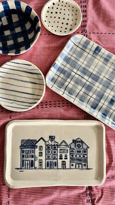 four dishes are sitting on top of a red and white checkered tablecloth,