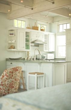 there are two pictures of the same room in this house, one is empty and the other has white cabinets