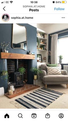 a living room with blue walls and a fireplace in the center, surrounded by potted plants