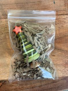 a plastic bag filled with sliced vegetables on top of a wooden table next to a red star