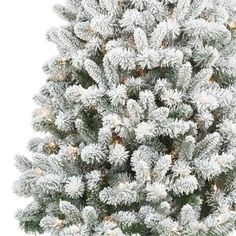 a white christmas tree with snow on it