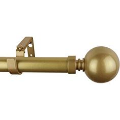 a gold curtain rod with a ball on it