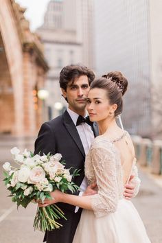 a bride and groom pose for a wedding photo