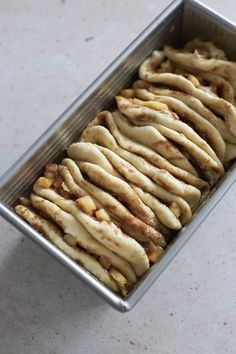 a pan filled with sliced bananas sitting on top of a counter