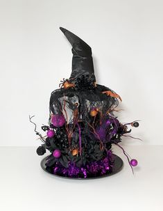 a witches hat with purple and black decorations