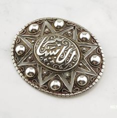 More Unique Sterling Silver Brooches: https://www.etsy.com/shop/SilverStarrs925?section_id=15203699 Beautiful  Silver Brooch That doubles as a pendant This brooch is 2 7/8 inches long It is 2 1/4 inches wide The brooch weighs 25.1 grams Design: Oval, Islamic Filigree  Markings: None, (Tested & guaranteed to be sterling silver) Condition: Very good, estate, cleaned Stock# B1332 NOTE: Variations in color in the pictures are due to reflections. The actual color is a beautiful even silver. Thank you Unique Sterling Silver Brooch In Silver, Traditional Engraved Brooches For Gift, Traditional Silver Brooches For Formal Occasions, Unique Silver Brooches As Gift, Silver Brooch With Intricate Design Gift, Silver Brooch With Intricate Design As Gift, Silver Brooch With Large Pendant As Gift, Silver Sterling Silver Pendant Brooches, Sterling Silver Oval Brooch Jewelry