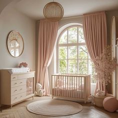 a baby's room with pink drapes, curtains and a crib in front of a large window