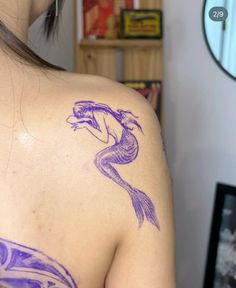 a woman with a purple tattoo on her back