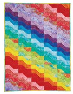 a multicolored quilt on a white background