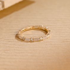 a diamond ring sitting on top of a wooden table