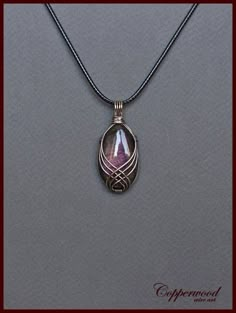 a necklace with a pendant hanging from it's side