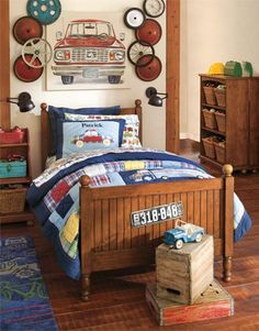 a bed room with a neatly made bed and toy cars on the bedspread