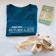 there is a t - shirt and ballet shoes on the bed