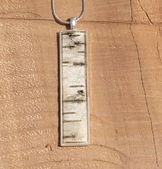 This pendant is 1/2 by 2 inches long  Poured artist resin covers the birch bark sourced from a fallen tree in New Hampshire.  Silver thin pendant and includes an 16 inch  silver necklace with  clasp. Ships in 1 day.   The necklace will be packaged in a custom gift box with a birch bark cover.  Variations available. Thanks for looking. Handmade in my shop in Boston MA and will be packaged and shipped with care.  These are one of my most popular shapes. ✨ Feel Free to CONNECT!! ** Visit my website Birch Bark Jewelry, Birchbark Crafts, Birch Bark Crafts Diy, Birch Bark Art, Tree Bark Crafts, Birch Wood Crafts, Birch Jewelry, Bark Crafts, Birch Bark Crafts